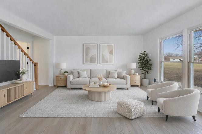 Bright renovated living room with new light wood flooring