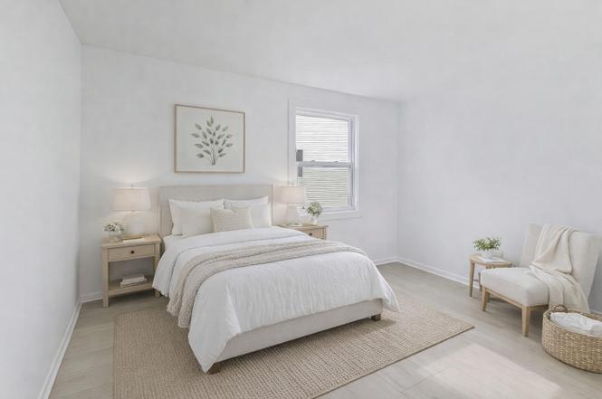 Staged bedroom with soft neutral finishes and new flooring
