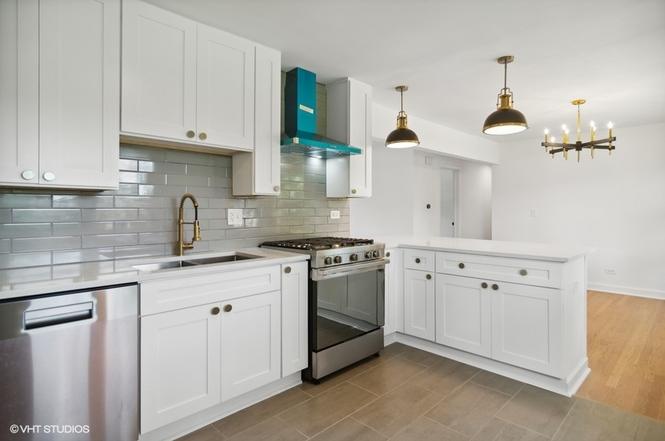Renovated kitchen with white shaker cabinets and stainless appliances